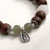 A brown beaded bracelet with green jade beads, white carved beads and silver ornaments of the character "Fu" Application Scenario